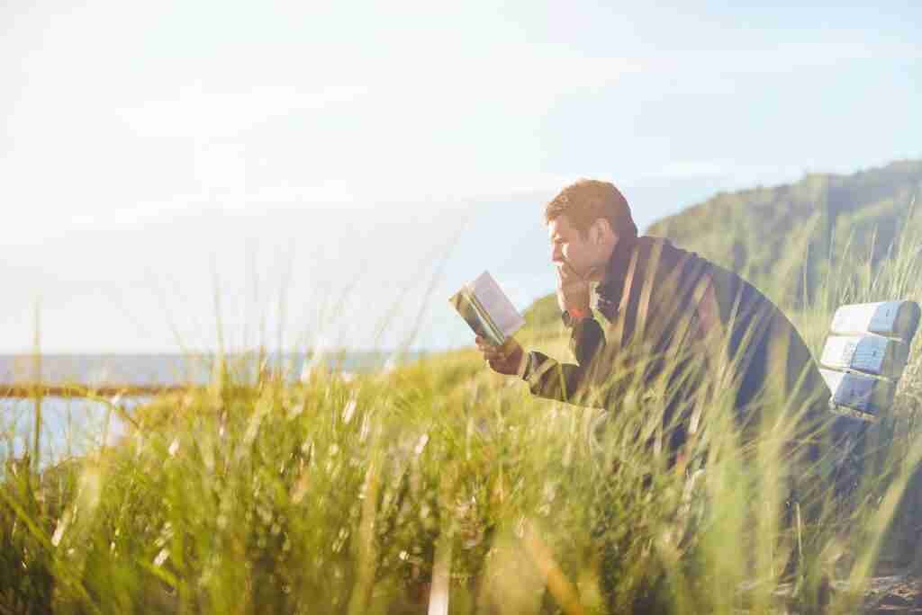 Man reading a book outside