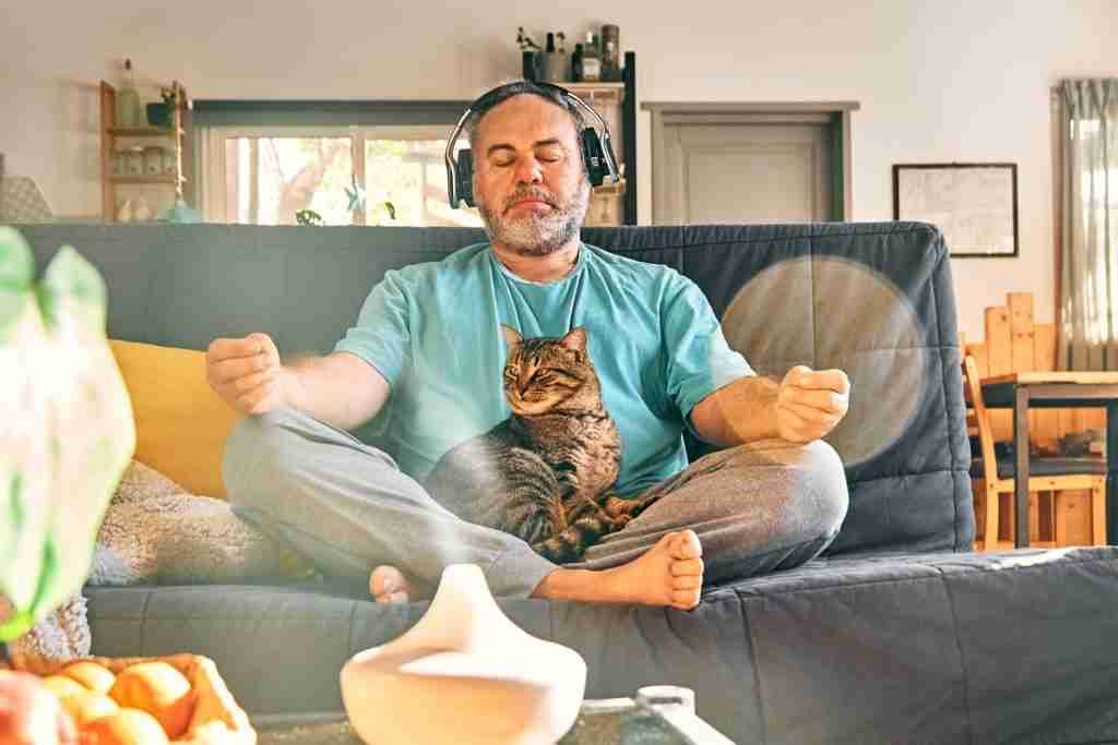 A man at home doing meditation with his car.