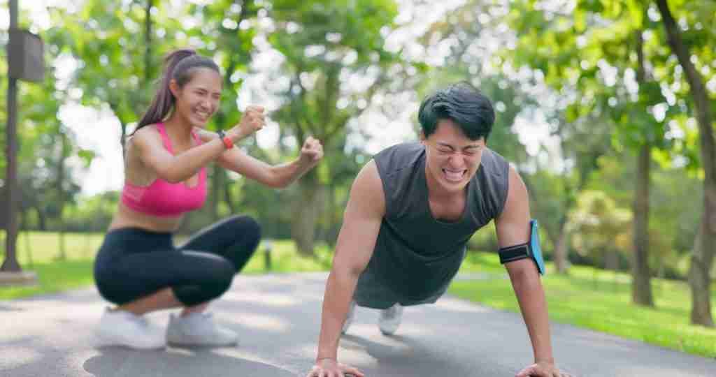 Couple exercising and cheering each over on