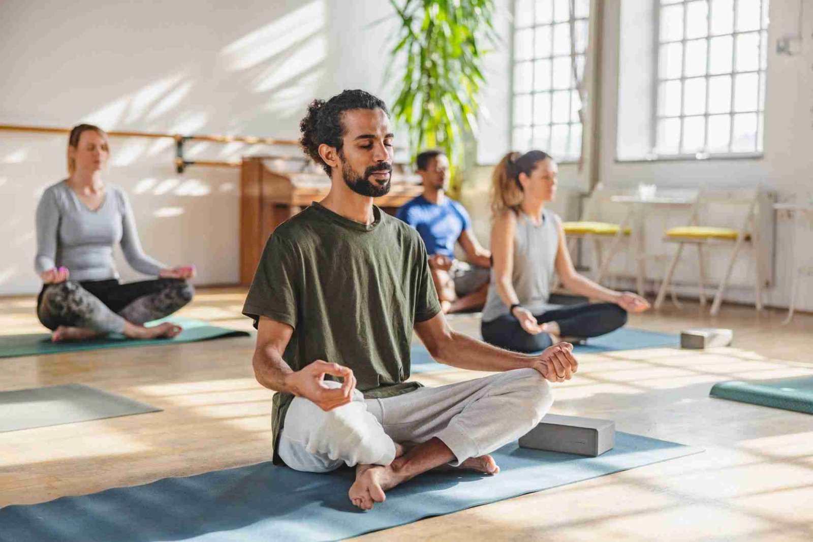 Male Meditating In A Yoga Class