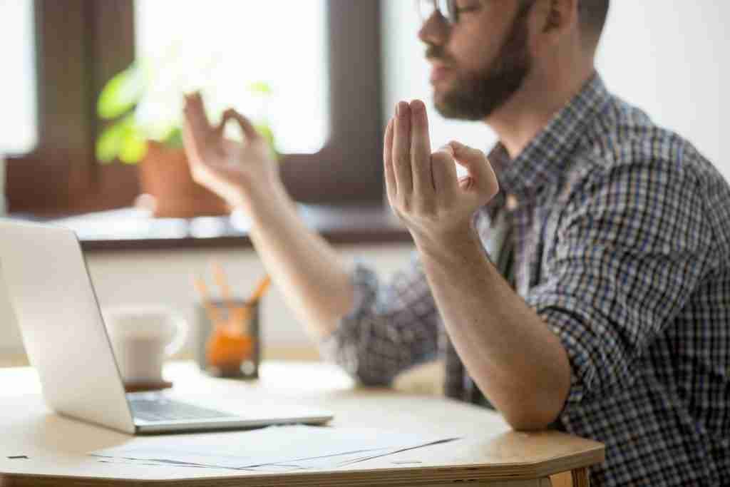 Man doing meditation at work