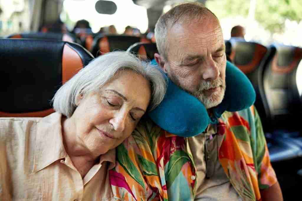 Senior couple napping on motor coach