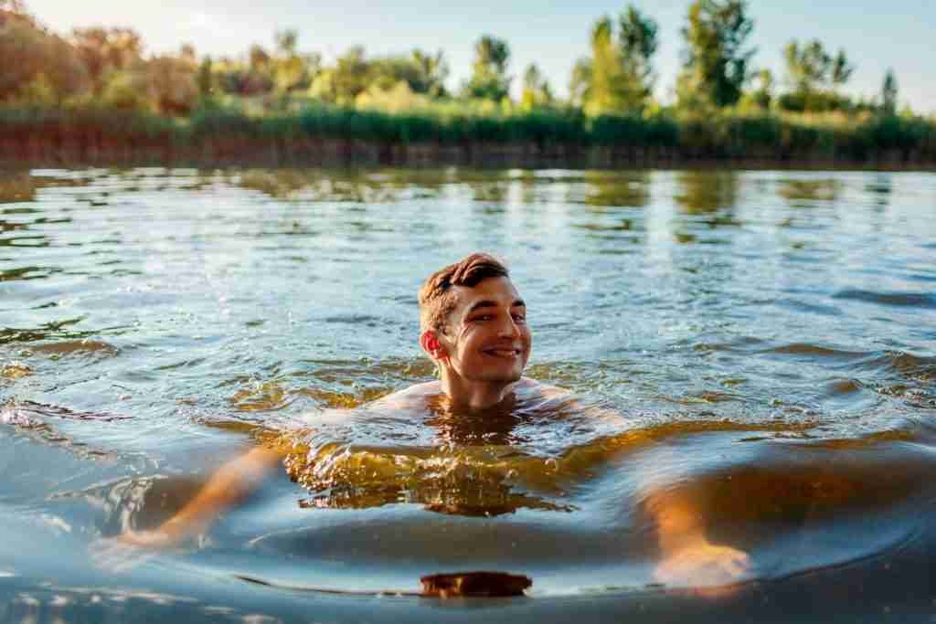 man swimming in the river