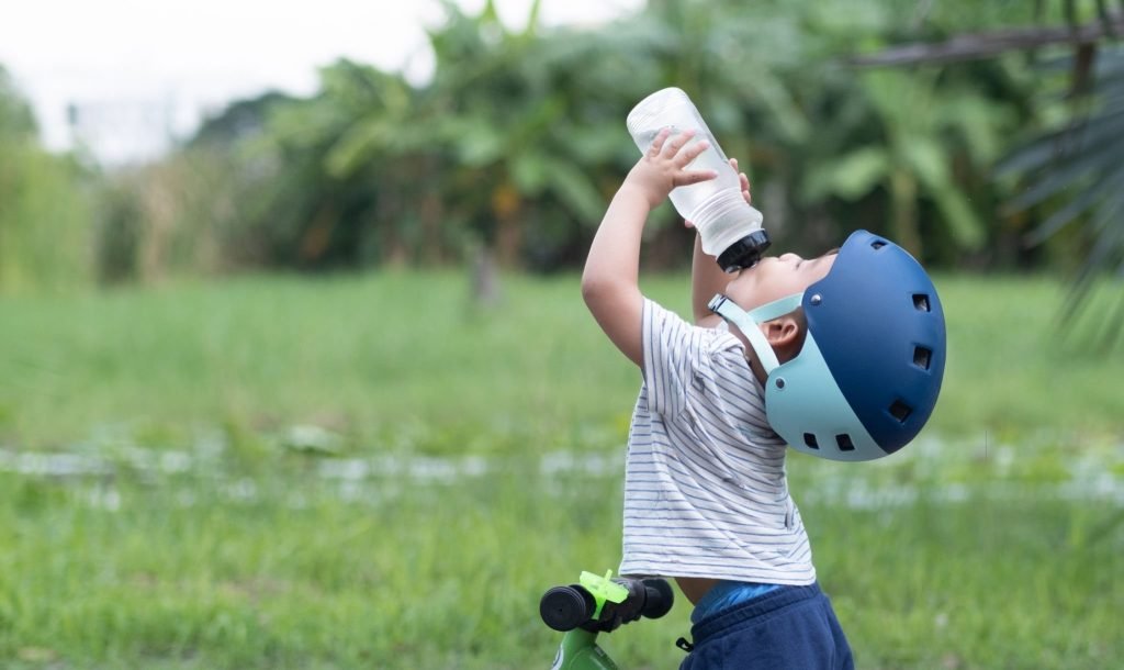 A young boy drinking water