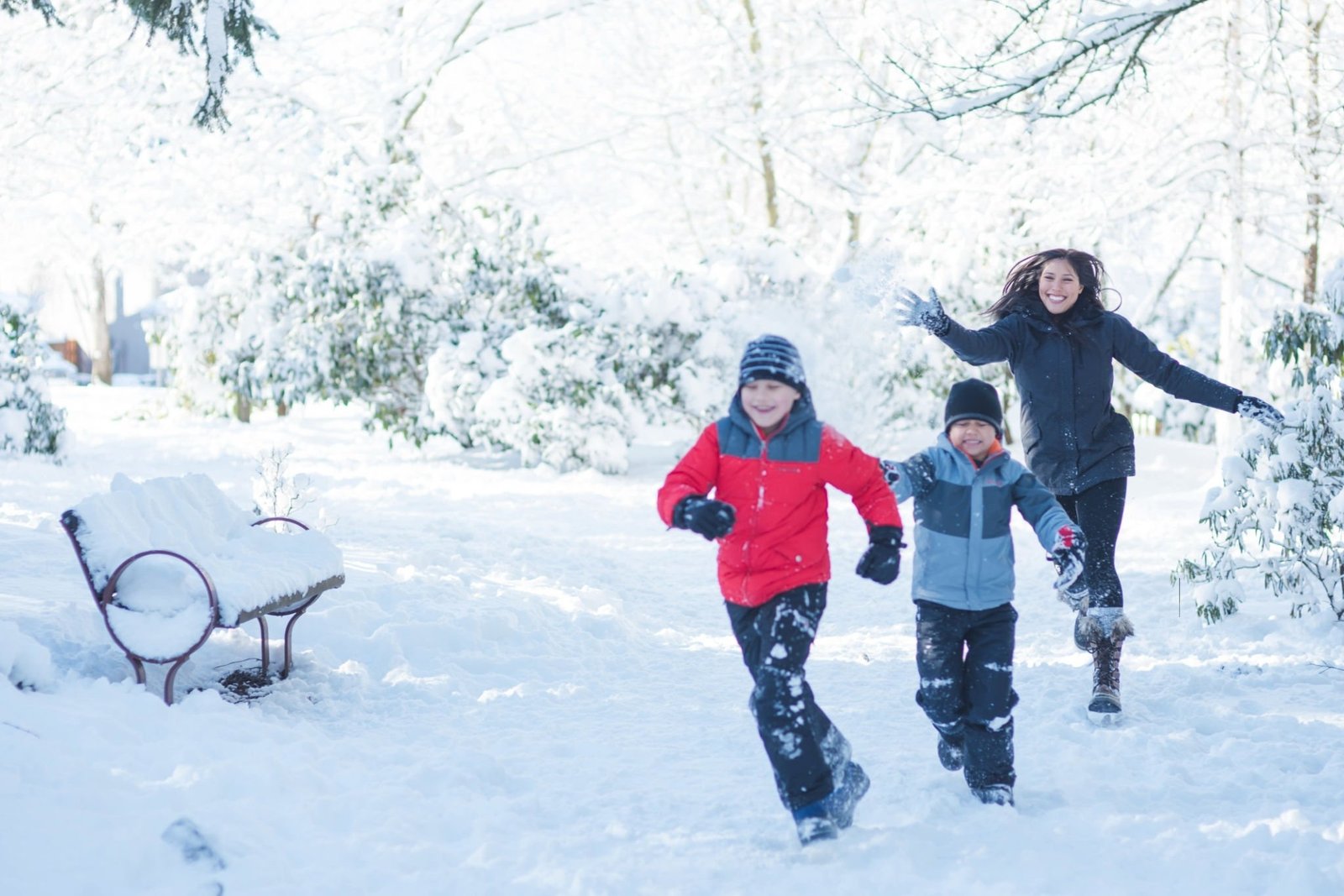 Mom and sons playing in snow 