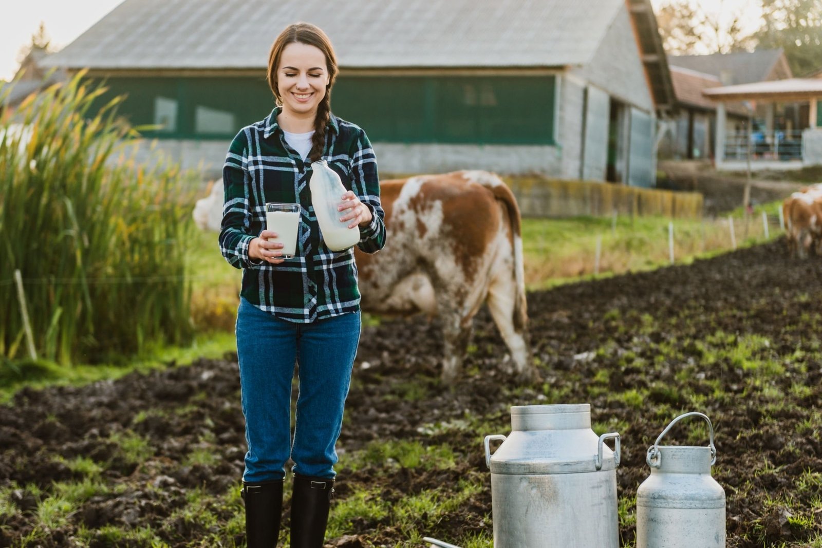 woman holding milk bottle with glass on dairyfarm