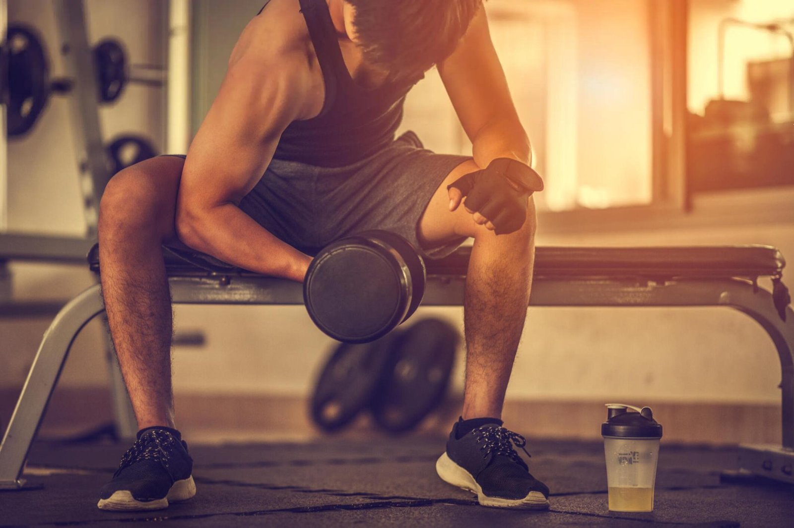 A guy using weights to build muscle