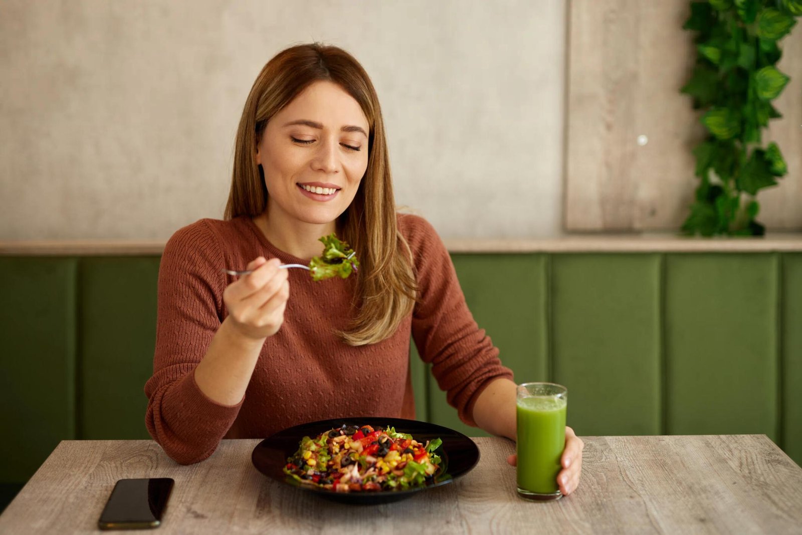 A person looking relaxed and content while eating a nourishing meal.