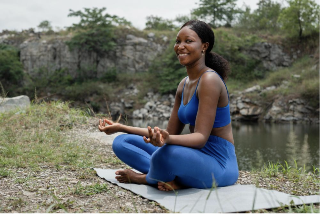 A lady doing meditation outside.