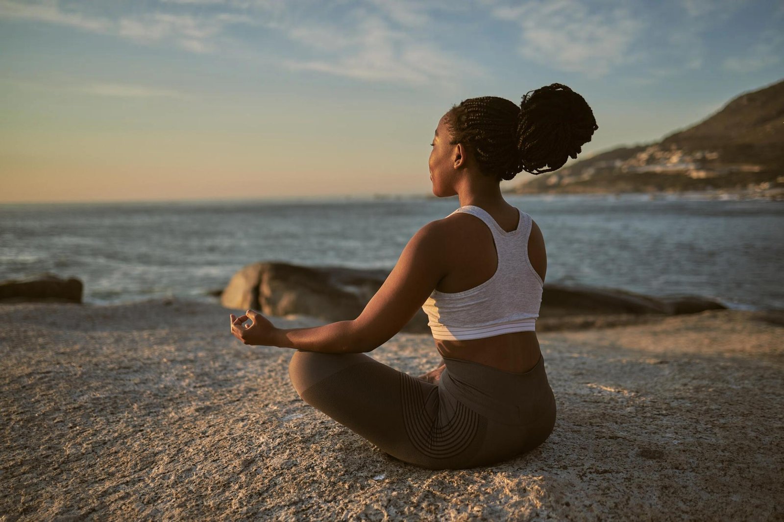 Women doing meditation on the beach